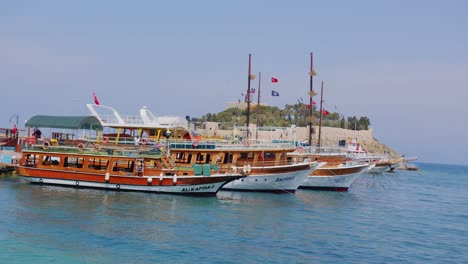 Tourist-boats-moored-on-mediterranean-sea-coast-in-Kusadasi,-Turkey