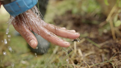 SLOW-MOTION---Hose-being-used-to-wash-asian-hands-during-gardening