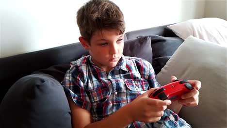 Boy-Is-Playing-Video-Game-On-Gaming-Console-Nintendo-Switch---Zoom-Out