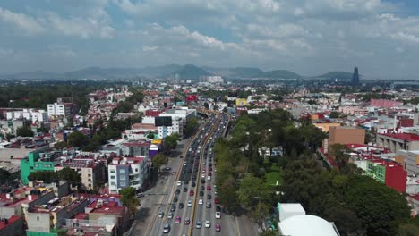 Drone-Flying-Over-Busy-Long-Highway,-Famous-Circuito-Interior-Avenue,-Mexico-City