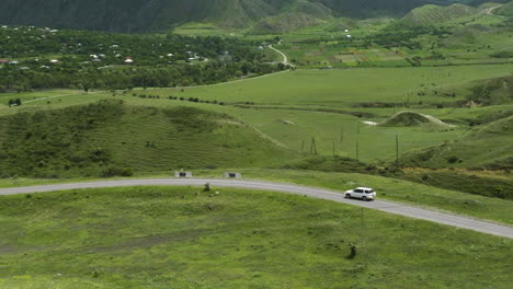 SUV-Car-Driving-On-The-Road-Through-Rural-Landscape-Near-Aspindza-In-Georgia
