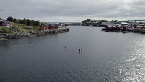 Forwarding-shot-of-stand-up-paddlers-paddling-on-Lofoten-Island-on-a-nice-summer-day