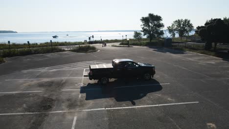 Drone-landing-in-a-seagull-filled-parking-lot-in-Muskegon,-MI