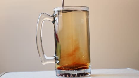 Close-up-steady-shot-tea-dissolved-and-puring-in-hot-water