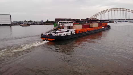 Barge-With-Cargo-Containers-Sailing-In-The-Oude-Maas-River-To-Arch-Bridge