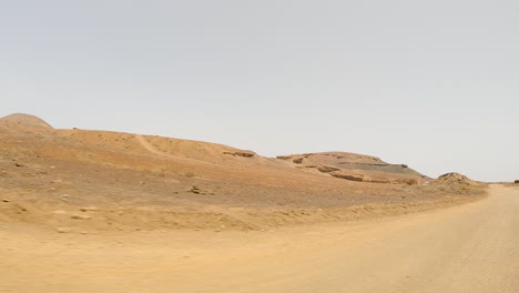 Driving-On-Desert-Road-Landscape-On-A-Sunny-Day-In-Fuerteventura,-Canary-Islands,-Spain