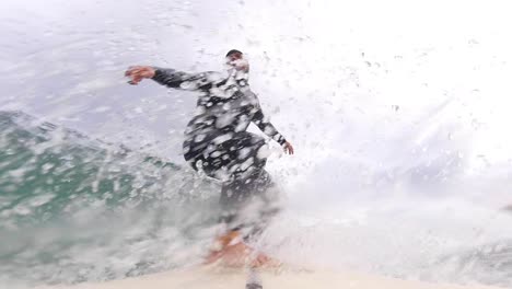 Close-up-slow-motion-shot-of-Handsome-guy-surfing-a-green-wave-in-Portugal