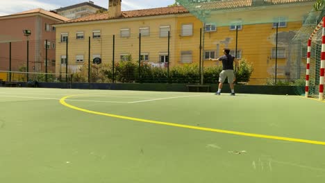 Young-man-tennis-player-training-on-indoor-court,-practicing-serve-in-Lisbon,-Portugal