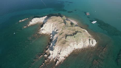 Circle-flights-with-a-drone-over-a-small-virgin-island,-in-Croatia