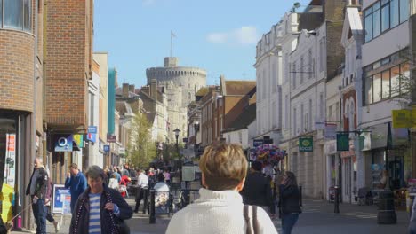 Shoppers-walking-on-Peascod-street-Windsor,-United-Kingdom-on-a-clear-Spring-day-in-March