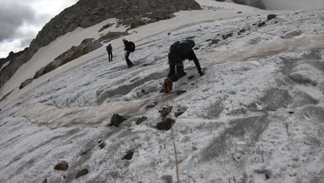 An-alpinist-falls-because-of-slippery-ice-on-a-glacier-in-the-swiss-alps,-adventure