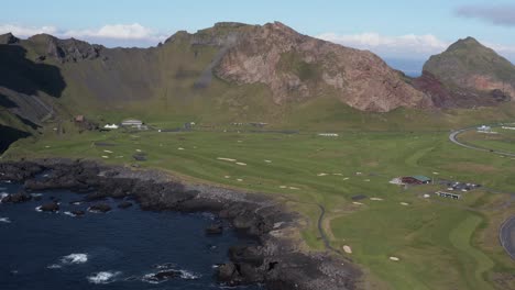 Vestmannaeyja-golf-club-course-on-Vestmannaeyjar-volcanic-island,-aerial