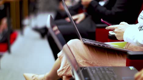 Unrecognizable-people-in-formal-wear-using-laptops-during-conference