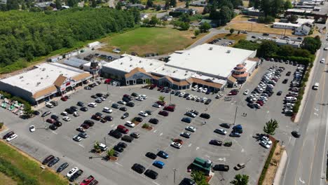 Orbiting-aerial-view-of-a-shopping-area-with-multiple-storefronts-on-Whidbey-Island