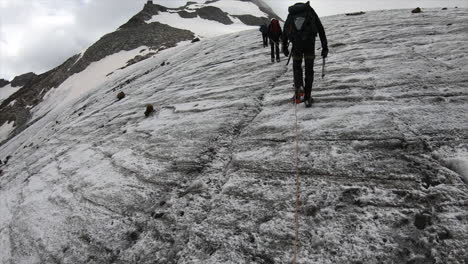 Mountaineering,-ascent-on-a-very-steep-glacier-with-crampons-and-pickaxes,-crystal-seeker-in-the-Swiss-Alps