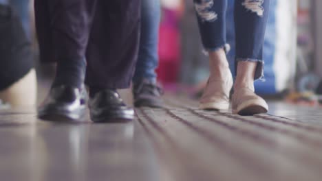 Slow-motion,-crowd-of-people's-feet-in-casual-wear-walking-indoors