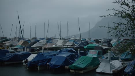 Mountain,-boats,-docked,-windy,-fog,-lake,-rain,-cloudy,-storm,-moody,-switzerland,-early-morning,-hergiswil,-harbor,-europe