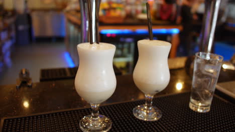 Two-pina-colada-cocktails-on-a-bar