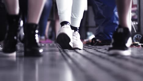 Unrecognizable-people's-feet-in-casual-footwear-walking-indoors-in-slow-motion