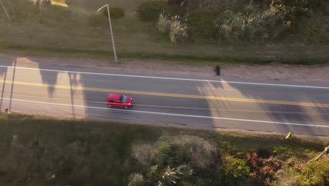 Red-car-driving-on-highway-of-Punta-del-Este-in-Uruguay