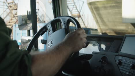 Close-up-shot-of-man-hands-driving-a-new-Volvo-truck-slowly