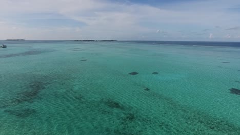 Panoramic-drone-shot-of-the-Indian-ocean-with-alley-of-water-villas-in-a-Maldives-resort