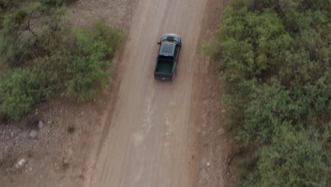Off-road-performance-pick-up-truck-speeding-down-desert-dirt-trail