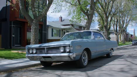 Vintage-car-blue-Mercury-parked-on-street-tilt