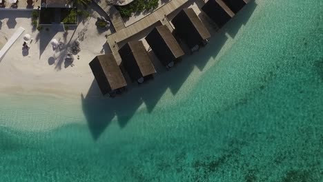 Drone-shot,-circle-movement-above-water-villas-spa-in-a-Maldives-resort