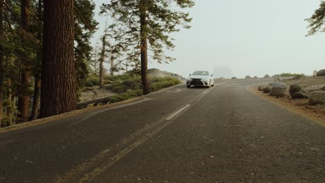 Luxury-Car-driving-down-Half-Dome-iconic-road