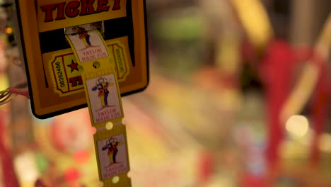 Tickets-spitting-out-from-arcade-machine,-slow-motion