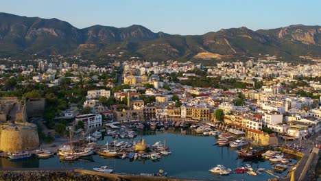 Aerial-zoom-out-of-Girne-or-Kyrenia-harbor-in-Cyprus-during-sunrise