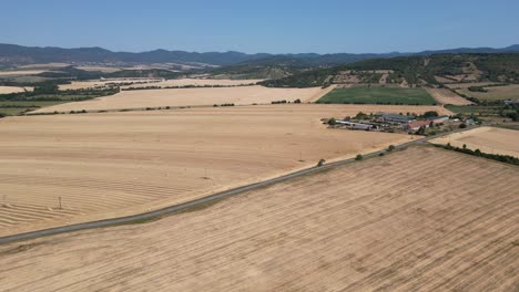 Aerial-view-panning-left-across-large-farms-and-fields-in-Slovakia