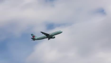Passenger-Airplane-Westjet-flyover-on-a-cloudy-day-close-up