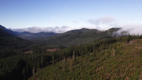 Beautiful,-slow-drone-footage-sweeping-across-the-clouds,-mountains,-and-valleys-of-Olympic-National-Park-in-Port-Angeles,-Washington