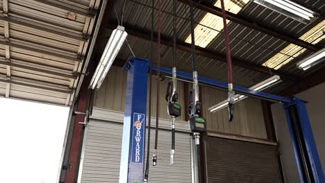 Hanging-oil-and-air-cables-mechanic-shop-pan-down