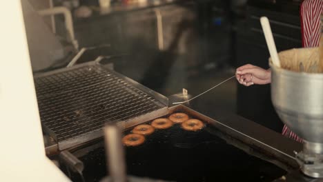 Donuts-frying-in-oil,-slow-motion