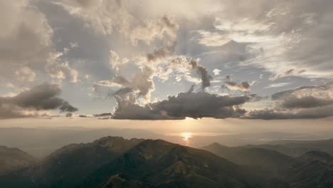 Aerial-of-backcountry-mountain-range-at-sunset-with-beautiful-cloud-formation-after-a-storm-1
