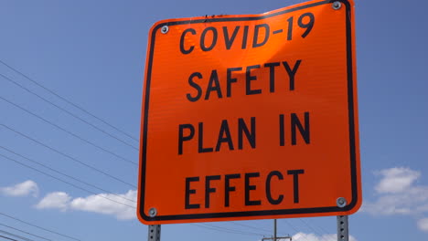 Slow-zoom-in-on-a-roadside-COVID-safety-sign