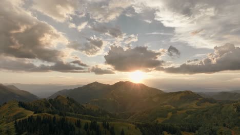 Aerial-of-backcountry-mountain-range-at-sunset-with-beautiful-cloud-formation-after-a-storm-4