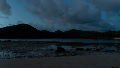 Low-tide-in-bay-of-remote-tropical-island-in-Fiji,-clouds-forming-in-sky,-timelapse