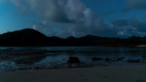 Rising-tide-on-tropical-island-during-day-to-night,-clouds-in-sky,-timelapse