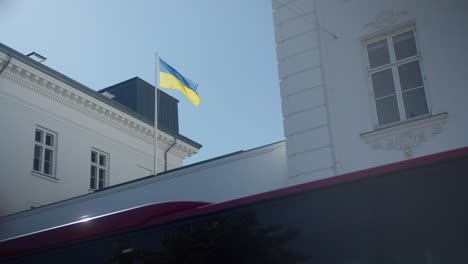 Ukrainian-flag-on-top-of-building-and-bus-driving-by