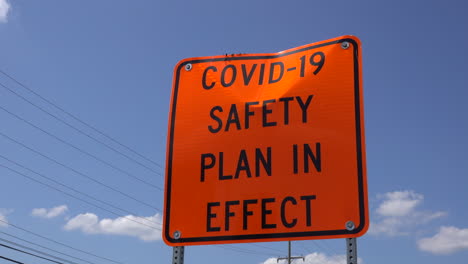 A-dented-COVID-safety-sign-seen-from-a-low-angle