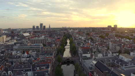 Drone-shot-over-Amsterdam-canal-towards-the-Oude-church-and-the-Basilica-of-Saint-Nicholas