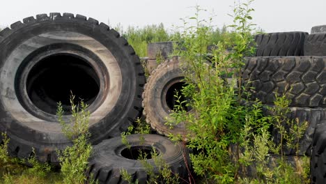4K-Drone-Video-of-Discarded-Giant-Excavator-Tire-Pile-in-wilderness-near-Fairbanks,-AK-during-Summer-Day-5