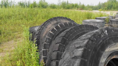 4K-Drone-Video-of-Discarded-Giant-Excavator-Tire-Pile-in-wilderness-near-Fairbanks,-AK-during-Summer-Day-4