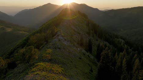 Aerial-FPV-over-backcountry-mountain-range-and-forest-at-sunset