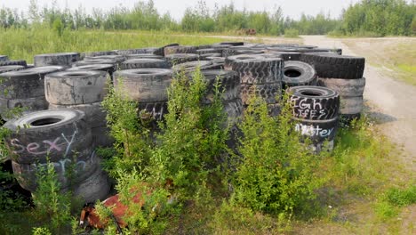 4K-Drone-Video-of-Discarded-Giant-Excavator-Tire-Pile-in-wilderness-near-Fairbanks,-AK-during-Summer-Day-3
