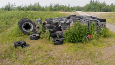 4K-Drone-Video-of-Discarded-Giant-Excavator-Tire-Pile-in-wilderness-near-Fairbanks,-AK-during-Summer-Day-9
